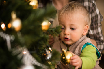 Closeup shot of a kid near xmas tree