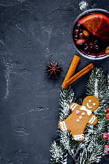 Christmas mulled wine with spices in cup on dark background