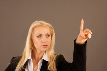 Beautiful business woman presing avirtual button on a transparent board