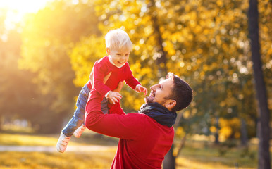 Fototapeta premium happy family father and baby son on autumn walk