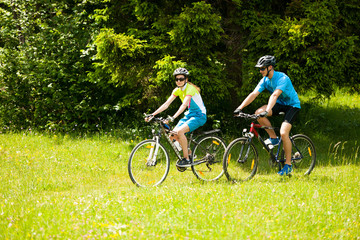 ACTIVE Young couple biking on a forest road in mountain on a spring day - 172068763