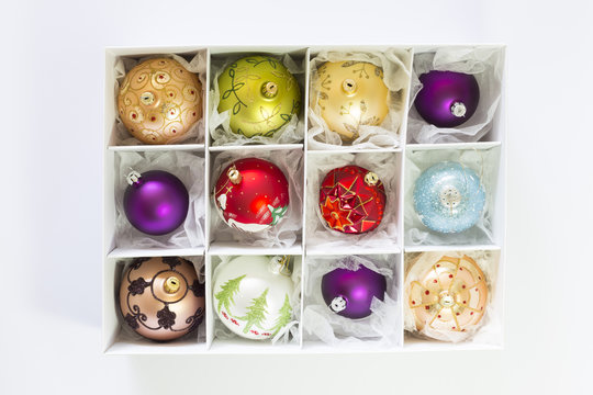White box with colorful ornate christmas balls on white background