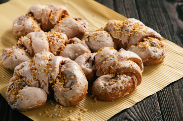 Croissant with almond filling on black wooden background.