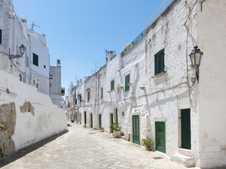 Narrow street in the white city of Ostuni, Puglia, Italy