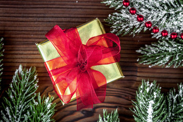 Fototapeta na wymiar gifts boxes with fir branches on wooden background top view