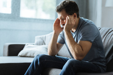 Sad handsome man having a headache
