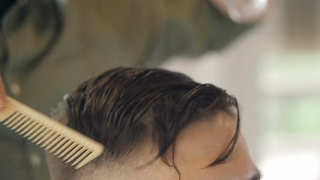 A slow motion of a male undercut styling in detail.    