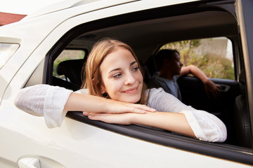 Family With Teenage Children In Car On Road Trip