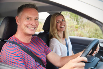 Portrait Of Mature Couple Sitting In Car On Road Trip