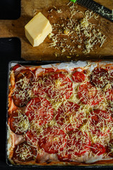 pizza with tomatoes and cheese on a dark background