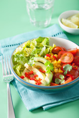 healthy vegan avocado salad with tomatoes and sweetcorn