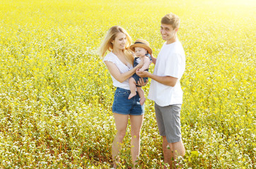 Fototapeta premium Young happy family with their infant boy