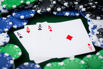 four kings on green background with poker chips