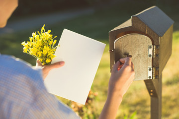 A letter box at the house. The postman sends a letter. Receiving a greeting card