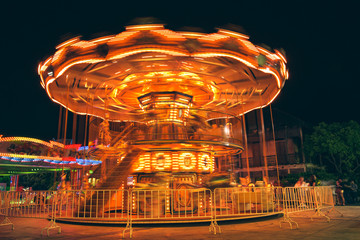 Selective focus to some part flying horse carousel, carnival background with Vintage filter.