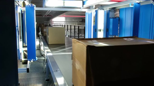 Parcels passing the automatic scan system stop button