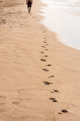Footprints of a man walking on the beach. Travel concept