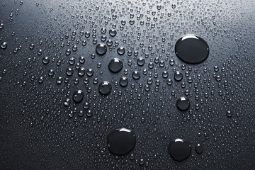 Water drops on a dark surface