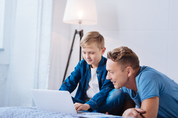 Pre-teen boy showing his presentation to father