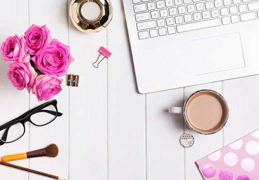 Modern stylish feminine workplace with coffee and roses