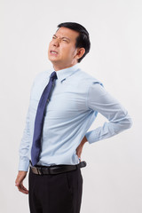 Fototapeta premium business man suffering from back pain, spinal injury