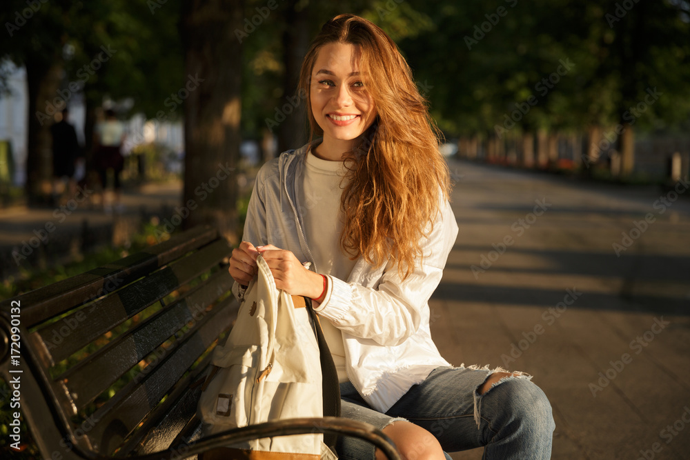 Wall mural side view of smiling brunette woman in autumn clothes