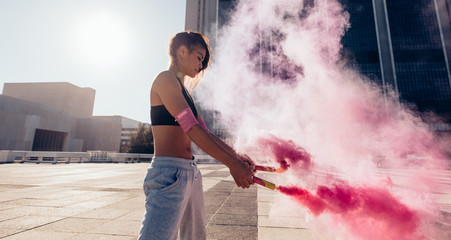 Woman with smoke grenade