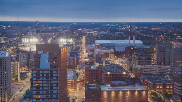 Detroit MI Cityscape Timelapse at Sunset with Downtown Traffic Lights Streaking from Driving Cars Between City Buildings and Stadiums