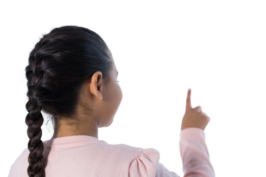 Girl pressing an invisible screen against white background