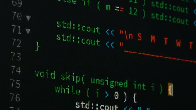Programmer scrolling up and down and checking code for editing futuristic technology concept with grain and dark tone processed