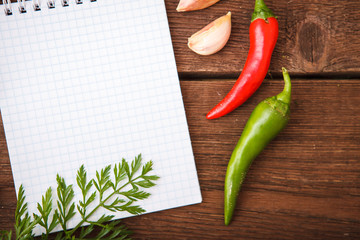 A sheet of paper with vegetables on a wooden background. view from above.