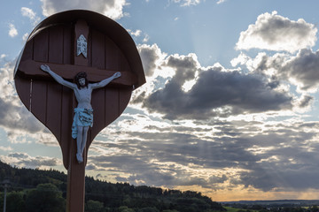 crucifix on a september evening sky in south germany rural area near city of stuttgart