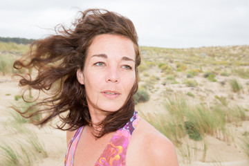 Portrait young woman smiling girl on beach wind in hair , summer holiday