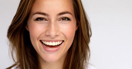 Beautiful brown eyed girl smiling in studio, portrait