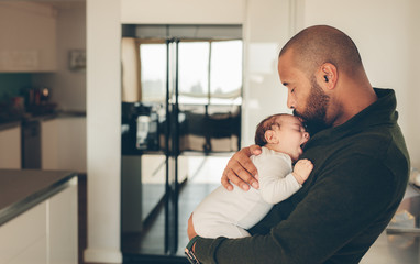 Cute little boy in his father's arms