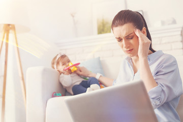 Obraz premium Serious female having terrible headache