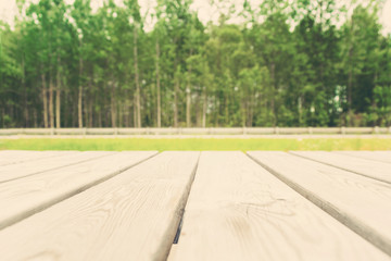 Wooden table  with copy space with forest view, toned photo