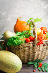 Fruits and vegetables with basket over wooden table, fall concept