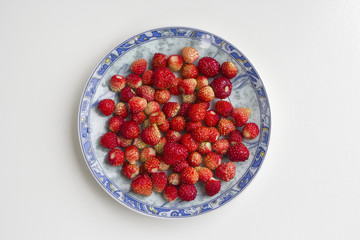 Strawberries in the plate, top view, isolated on white background. Top view.