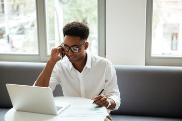 Handsome young african man sitting coworking