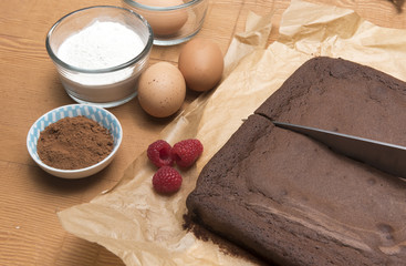 Chocolate brownie bake with flour, eggs, raspberries and coco powder 
