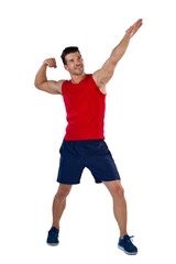 Full length of sports player flexing muscles with hand raised