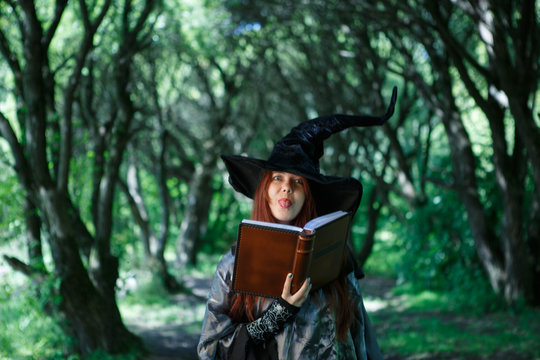 Photo of young witch with book