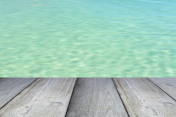 Gray wooden floor or pier with blue sea or ocean
