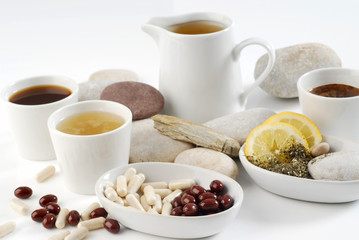 Diet pills with arrangement of coffee and tea cups