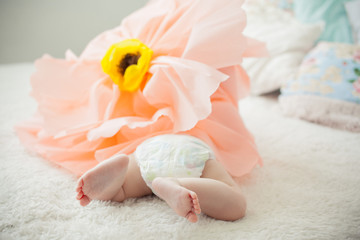 baby on the bed in a paper flower