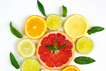 Fototapeta premium citrus food pattern on white background - assorted citrus fruits with mint leaves