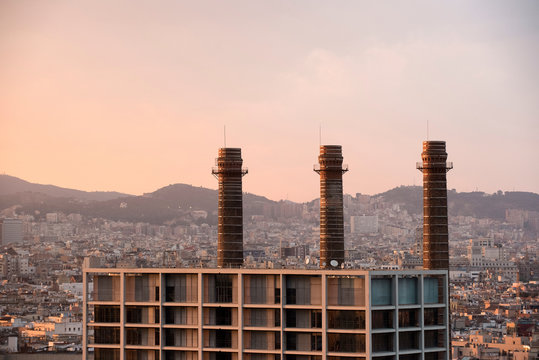 Elevated cityscape with row of smoke stacks, Barcelona, Spain