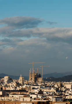 Cityscape view with Sagrada Familia and construction cranes, Barcelona, Spain