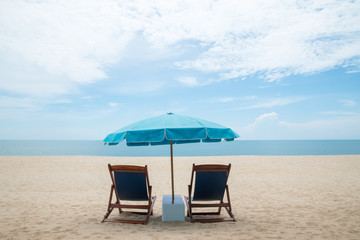 Beach chairs and blue umbrella on beautiful sand beach with cloudy and blue sky - 172115319